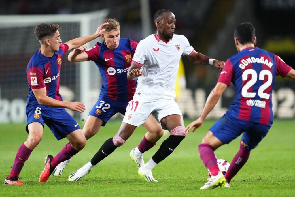 Barcelona players in action against Sevilla FC