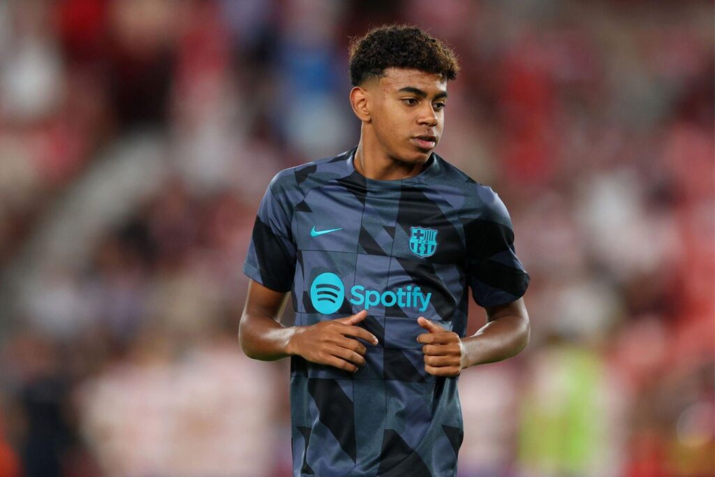 GRANADA, SPAIN - OCTOBER 08: Lamine Yamal of Barcelona looks on while warming up prior to the LaLiga EA Sports match between Granada CF and FC Barcelona at Estadio Nuevo Los Carmenes on October 08, 2023 in Granada, Spain.