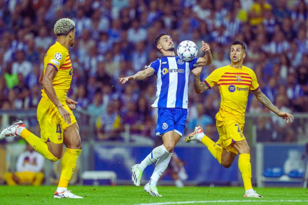 Stephen Eustaquio of Porto and João Cancelo of Barcelona in action during the UEFA Champions League match between FC Porto and FC Barcelona