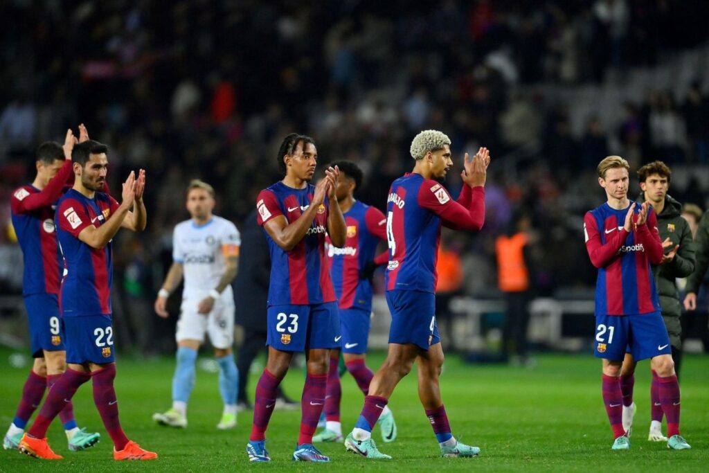 Barcelona's German midfielder #22 Ilkay Gundogan, Barcelona's French defender #23 Jules Kounde, Barcelona's Uruguayan defender #04 Ronald Araujo and Barcelona's Dutch midfielder #21 Frenkie de Jong react at the end of the Spanish league football match between FC Barcelona and Girona FC at the Estadi Olimpic Lluis Companys in Barcelona on December 10, 2023.