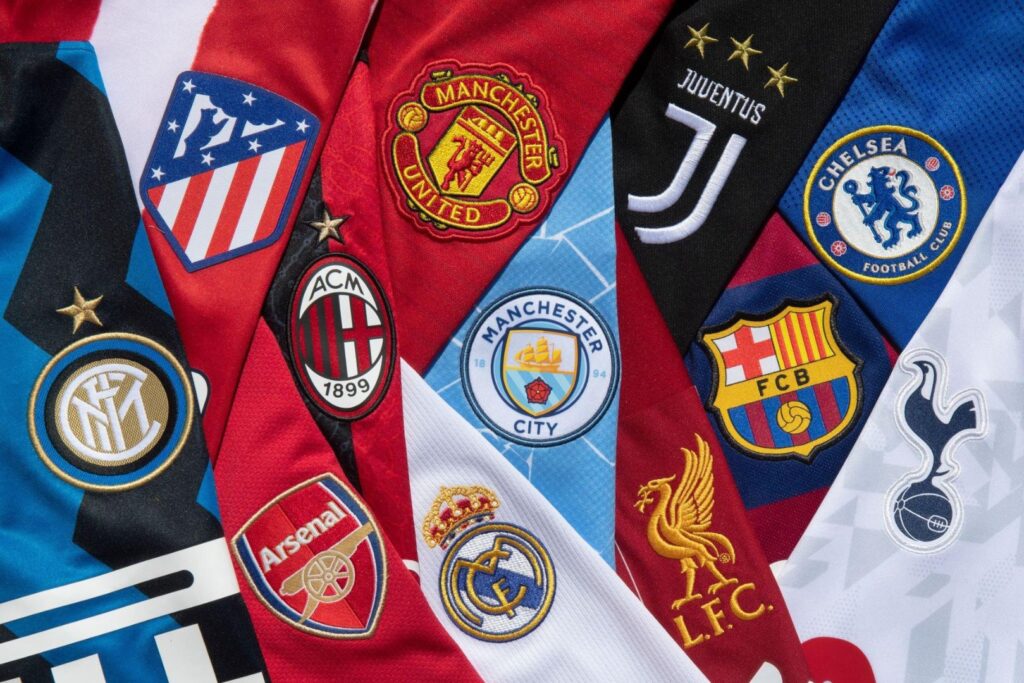 APRIL 24: The club badges on the home shirts of the twelve European Super League teams; Inter Milan, Atletico Madrid, AC Milan, Arsenal, Real Madrid, Manchester United, Manchester City, Juventus, Liverpool, Barcelona, Chelsea and Tottenham Hotspur on April 24, 2021 in Manchester, United Kingdom.