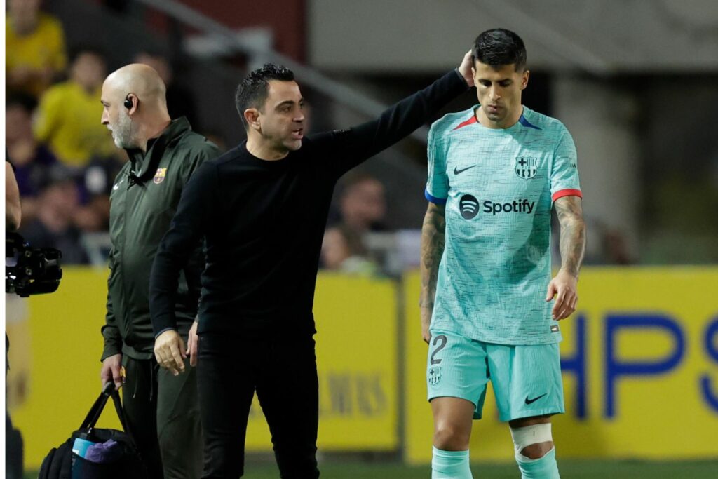 LAS PALMAS DE GRAN CANARIA, SPAIN - JANUARY 4: Coach Xavi Hernandez of FC Barcelona consoles Joao Cancelo of FC Barcelona who leaves the pitch with an injury during the LaLiga EA Sports match between Las Palmas v FC Barcelona at the Gran Canaria Stadium on January 4, 2024 in Las Palmas de Gran Canaria Spain