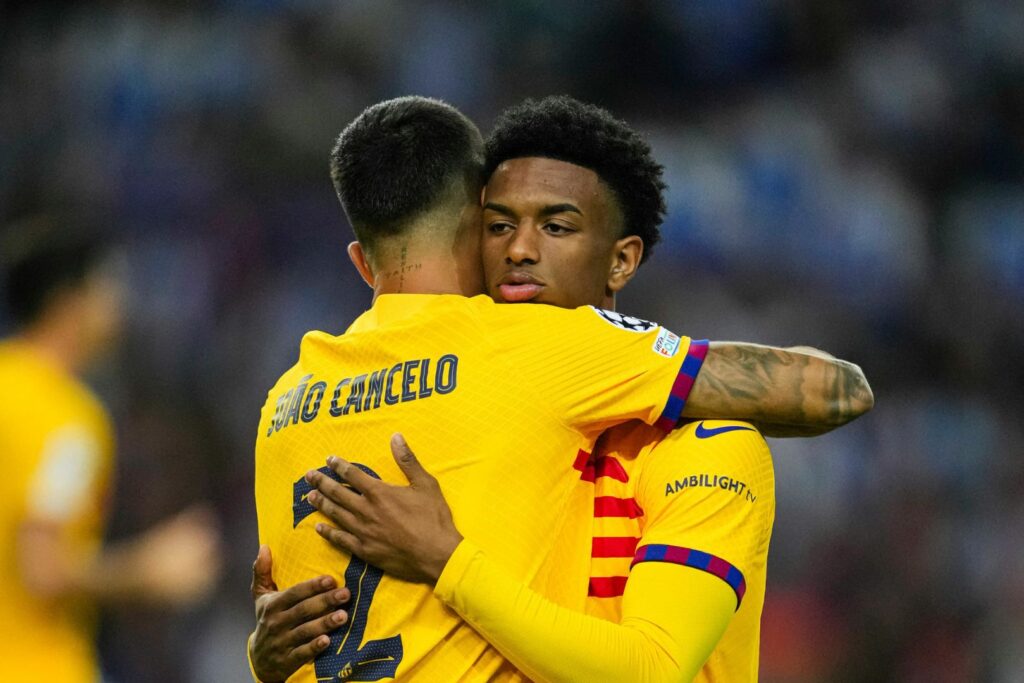 PORTO, PORTUGAL - OCTOBER 4: João Cancelo (L) high five his teammate Alejandro Balde of Barcelona (R) during the UEFA Champions League Group Stage Group H match between FC Porto and FC Barcelona at Estadio do Dragao on October 4, 2023 in Porto, Portugal.