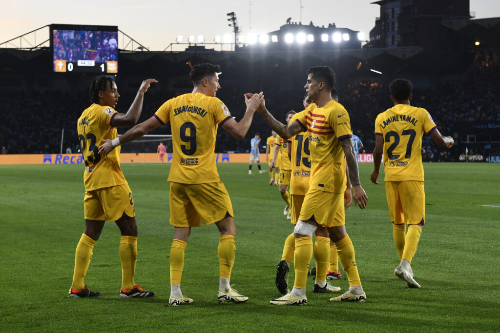 Barcelona's Polish forward #09 Robert Lewandowski celebrates with teammates scoring his team's first goal during the Spanish league football match between RC Celta de Vigo and FC Barcelona at the Balaidos stadium in Vigo on February 17, 2024.