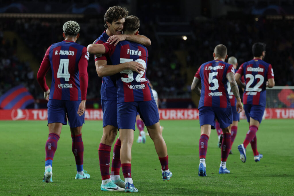 Barcelona's Spanish midfielder #32 Fermin Lopez is congratulated by Barcelona's Spanish defender #17 Marcos Alonso for scoring the second goal during the UEFA Champions League 1st round Group H football match between FC Barcelona and Shakhtar Donetsk at the Estadi Olimpic Lluis Companys in Barcelona on October 25, 2023.