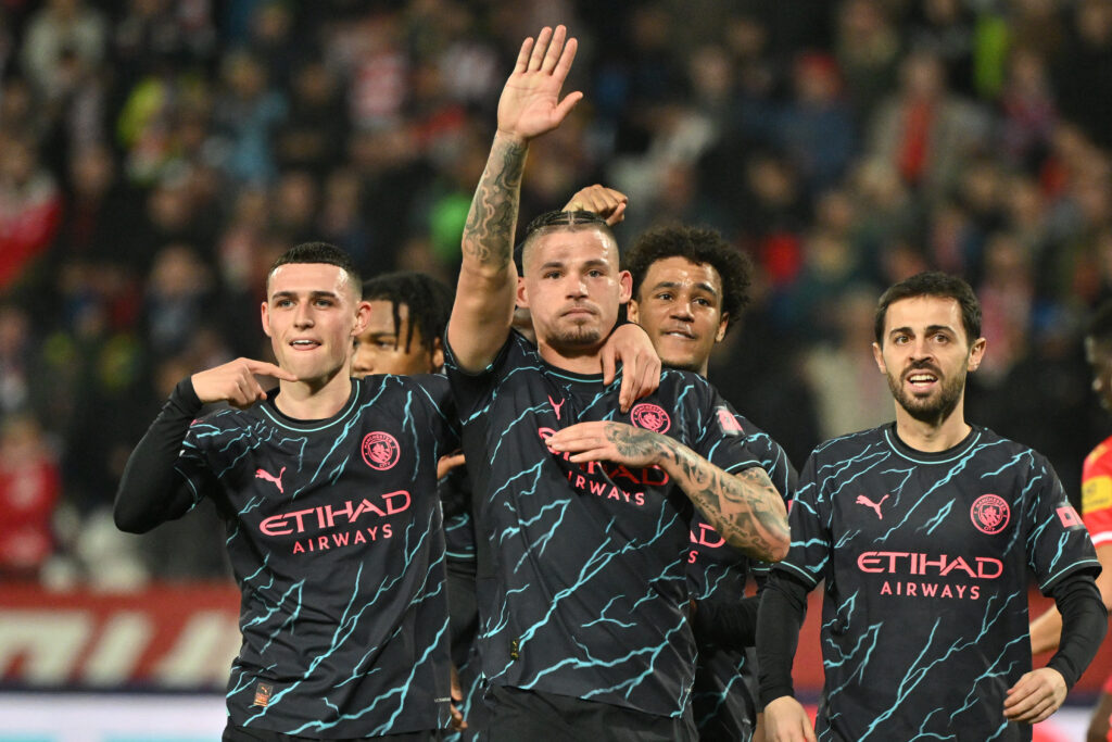 Manchester City's English midfielder #04 Kalvin Phillips (C) celebrates scoring his team's third goal with teammates after a penalty shot during the UEFA Champions League Group G day 6 group stage football match between Crvena Zvezda (Red Star Belgrade) and Manchester City at the Red Star stadium in Belgrade, on December 13, 2023.