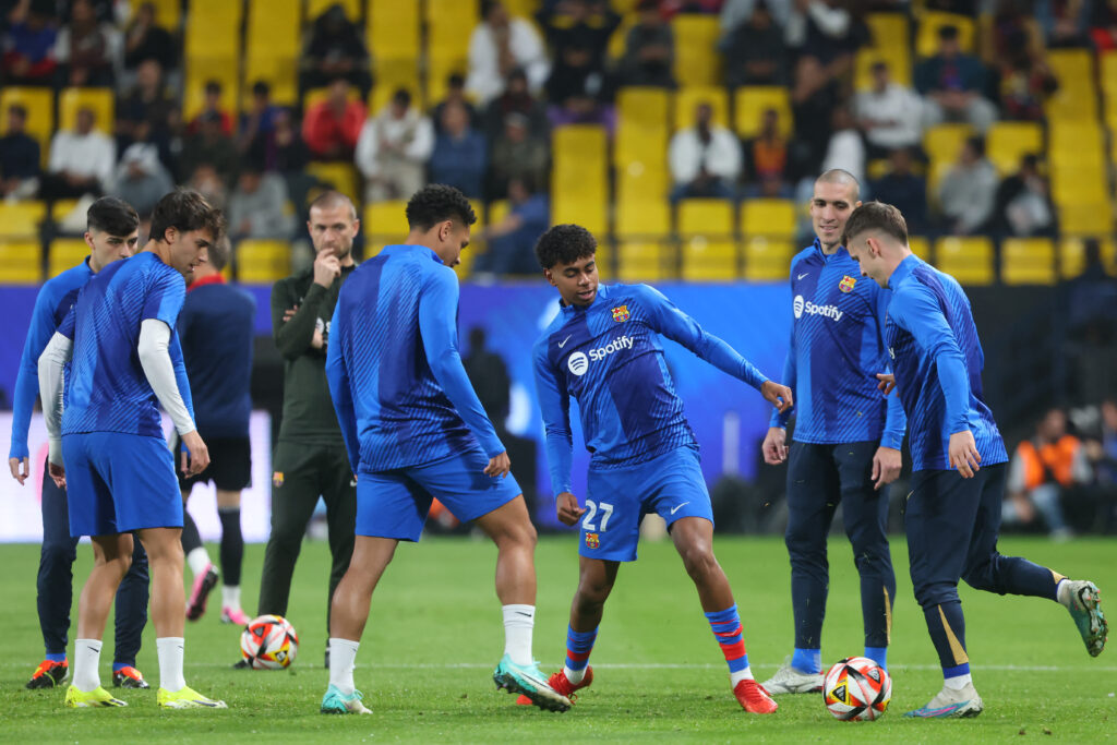 Barcelona's Spanish forward #27 Lamine Yamal warms up with teammates ahead of the Spanish Super Cup semi-final football match between Barcelona and Osasuna at the Al-Awwal Park Stadium in Riyadh, on January 11, 2024.