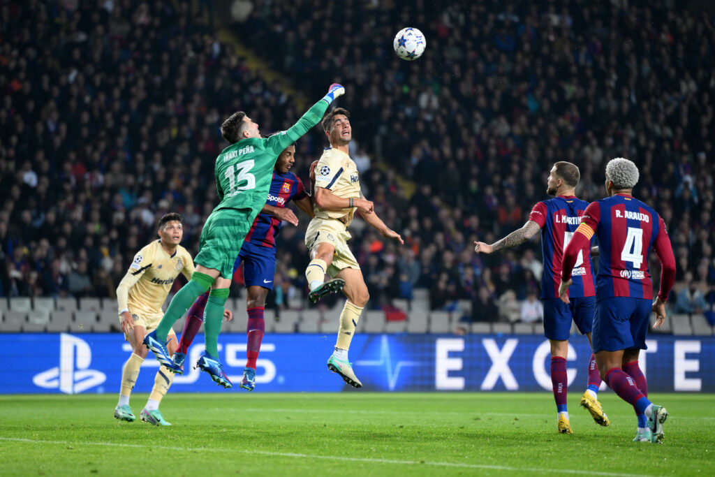 BARCELONA, SPAIN - NOVEMBER 28: Inaki Pena of FC Barcelona makes a save from Fabio Cardoso of FC Porto during the UEFA Champions League match between FC Barcelona and FC Porto at Estadi Olimpic Lluis Companys on November 28, 2023 in Barcelona, Spain.