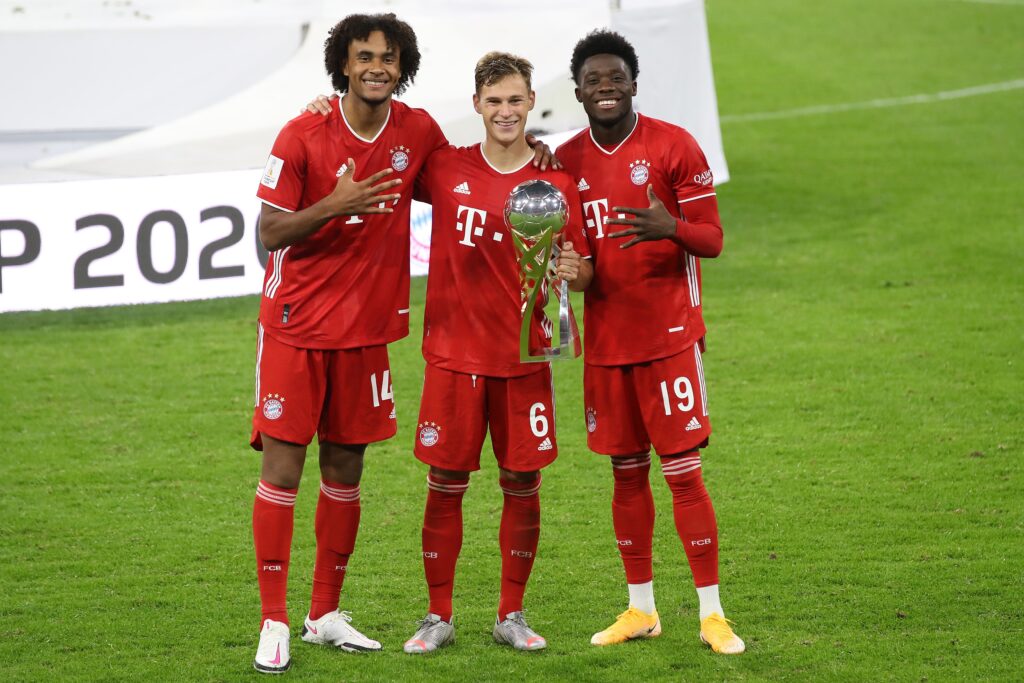 MUNICH, GERMANY - SEPTEMBER 30: (L-R) Joshua Zirkzee, Joshua Kimmich and Alphonos Davies of FC Bayern München celebrate with the Supercup trophy after the Supercup 2020 match between FC Bayern München and Borussia Dortmund at Allianz Arena on September 30, 2020 in Munich, Germany.