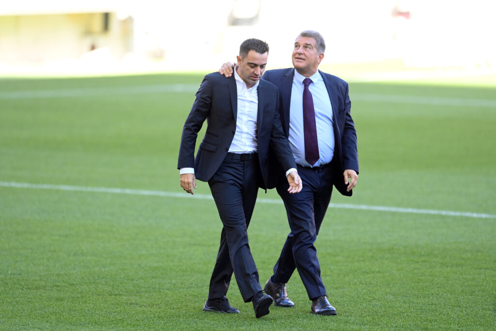 BARCELONA, SPAIN - NOVEMBER 08: New FC Barcelona Head Coach Xavi Hernandez (L) and Joan Laporta, President of FC Barcelona walk across the pitch during a press conference at Camp Nou on November 08, 2021 in Barcelona, Spain.