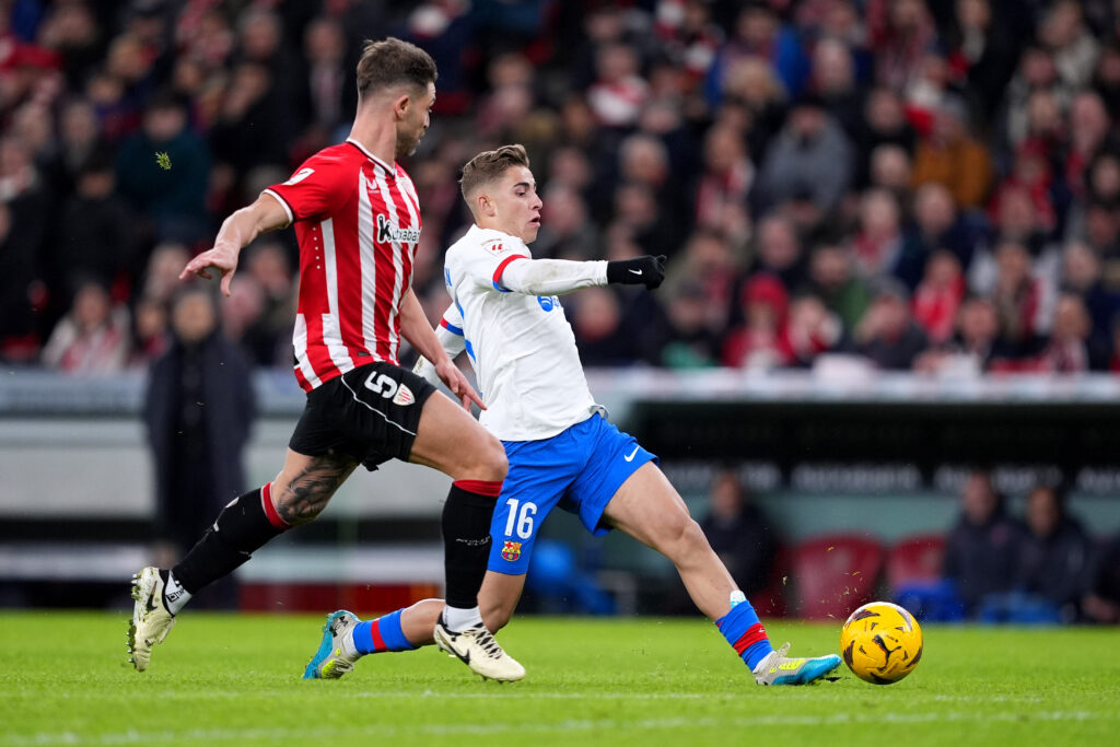 BILBAO, SPAIN - MARCH 03: Fermin Lopez of FC Barcelona shoots whilst under pressure from Yeray of Athletic Club during the LaLiga EA Sports match between Athletic Bilbao and FC Barcelona at Estadio de San Mames on March 03, 2024 in Bilbao, Spain.