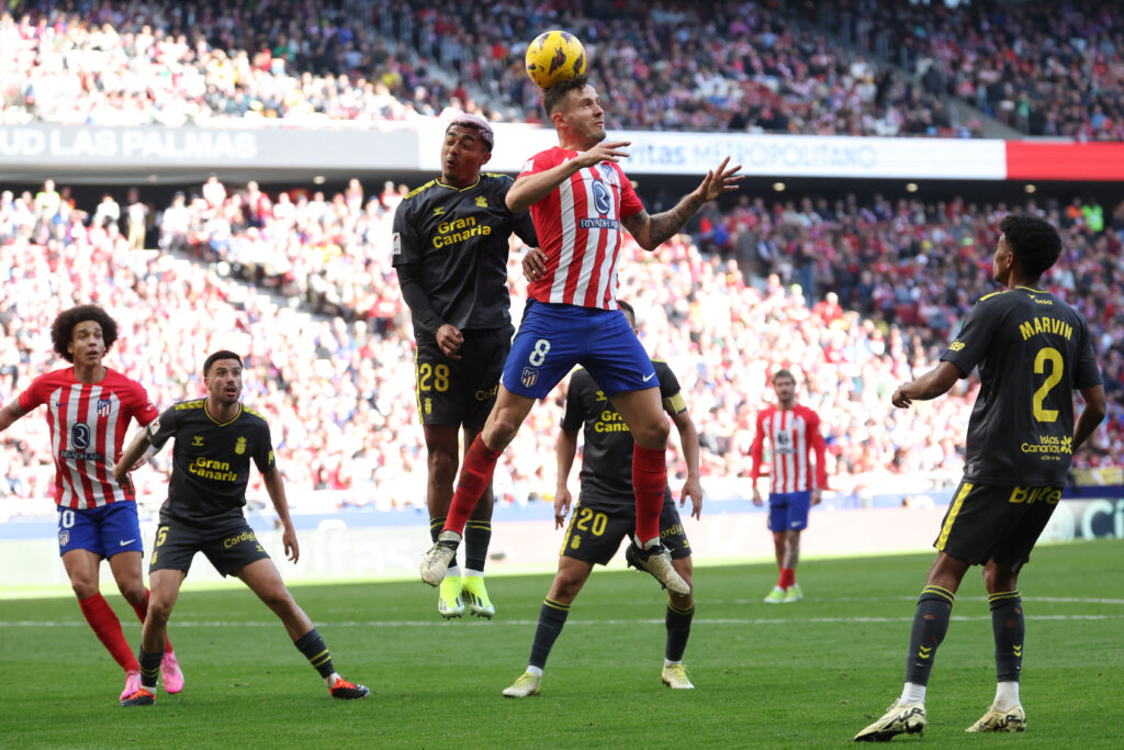 Las Palmas' Mexican defender #28 Julian Araujo and Atletico Madrid's Spanish midfielder #08 Saul Niguez vie for a header during the Spanish league football match between Club Atletico de Madrid and UD Las Palmas at the Metropolitano stadium in Madrid on February 17, 2024.