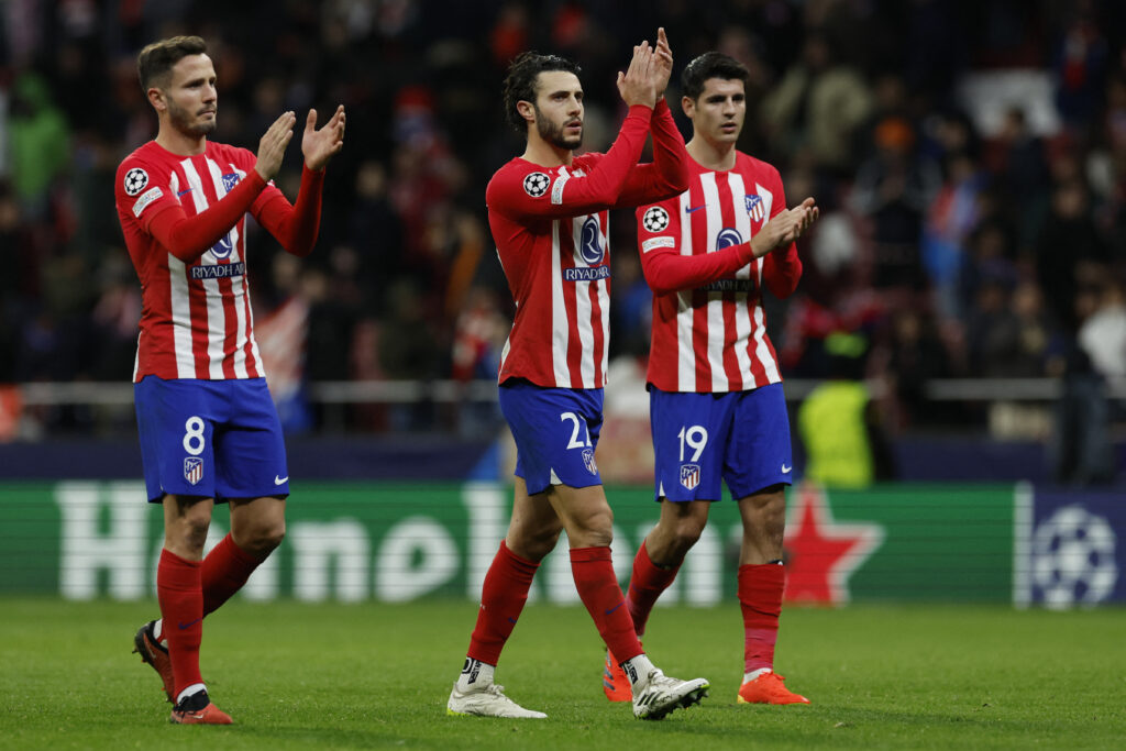 Atletico Madrid's Spanish midfielder #08 Saul Niguez, Atletico Madrid's Spanish defender #22 Mario Hermoso and Atletico Madrid's Spanish forward #19 Alvaro Morata applaud at the end of the UEFA Champions League group E football match between Club Atletico de Madrid and Lazio at the Metropolitano stadium in Madrid on December 13, 2023.