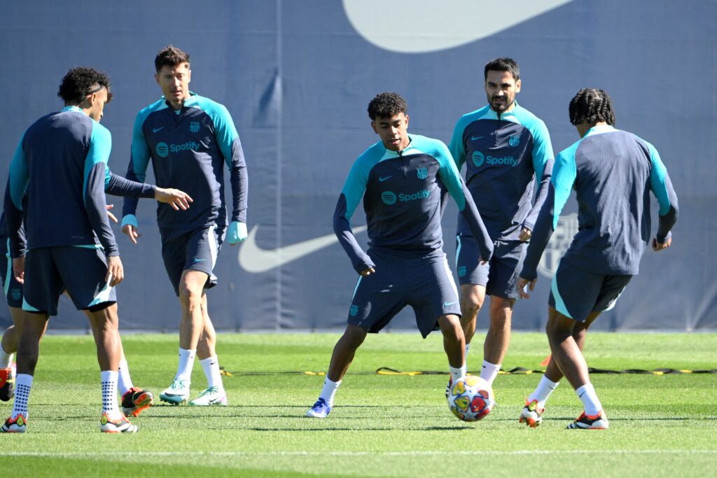 (From L) Barcelona's Polish forward #09 Robert Lewandowski, Barcelona's Spanish forward #27 Lamine Yamal and Barcelona's German midfielder #22 Ilkay Gundogan attend a training session on the eve of their UEFA Champions League last 16 second leg football match against SSC Napoli at the training center in Barcelona on March 11, 2024.