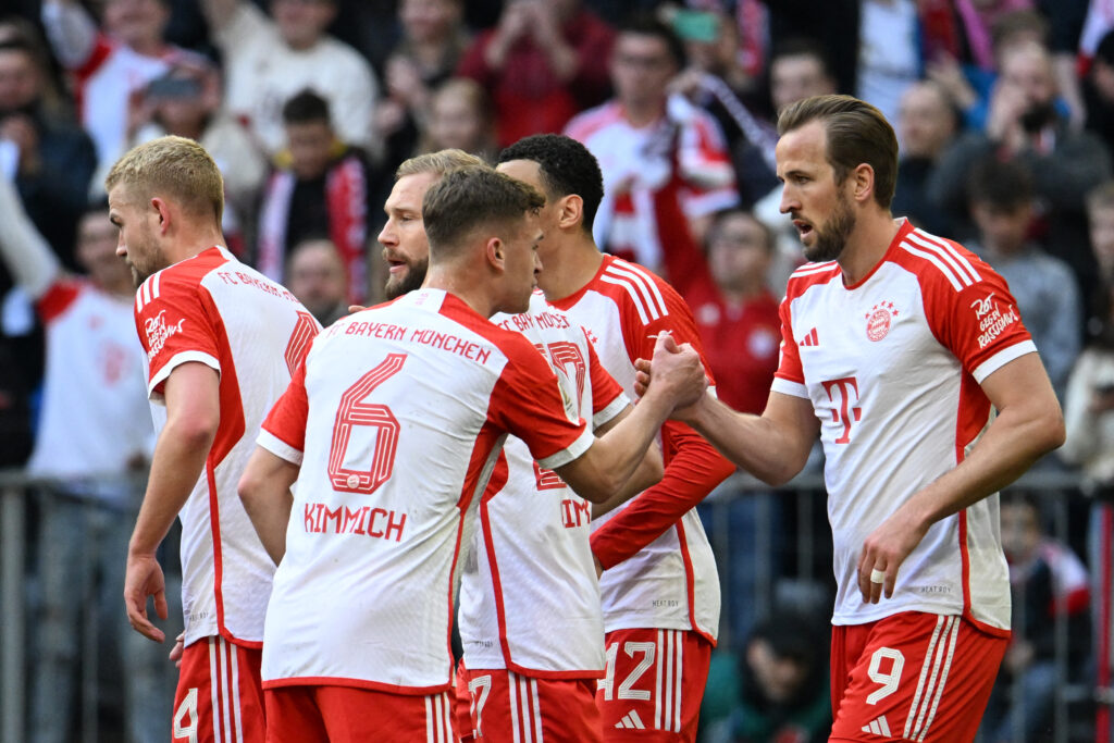 Bayern Munich's English forward #09 Harry Kane (R) celebrates scoring his team's first goal with Bayern Munich's German midfielder #06 Joshua Kimmich and team mates during the German first division Bundesliga football match FC Bayern Munich v 1 FSV Mainz 05 in Munich, southern Germany on March 9, 2024.