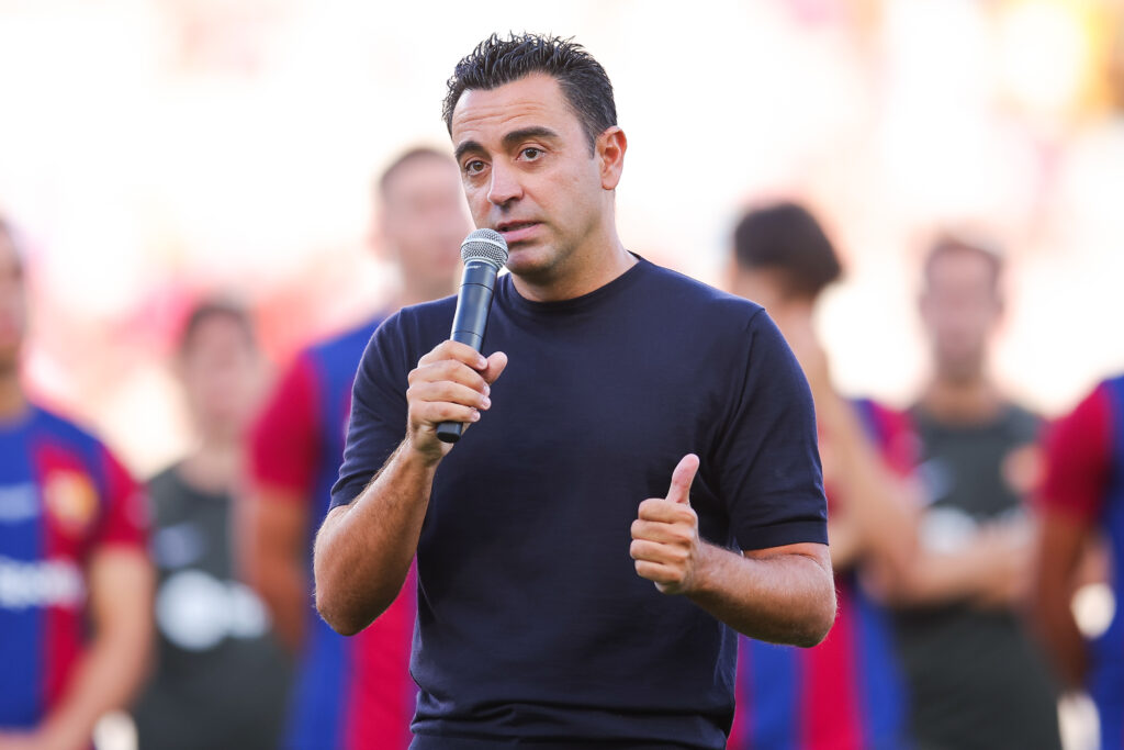 BARCELONA, SPAIN - AUGUST 08: Xavi Hernandez, head coach of FC Barcelona speaks to supporters prior the Joan Gamper Trophy match between FC Barcelona and Tottenham Hotspur at Estadi Olimpic Lluis Companys on August 08, 2023 in Barcelona, Spain.