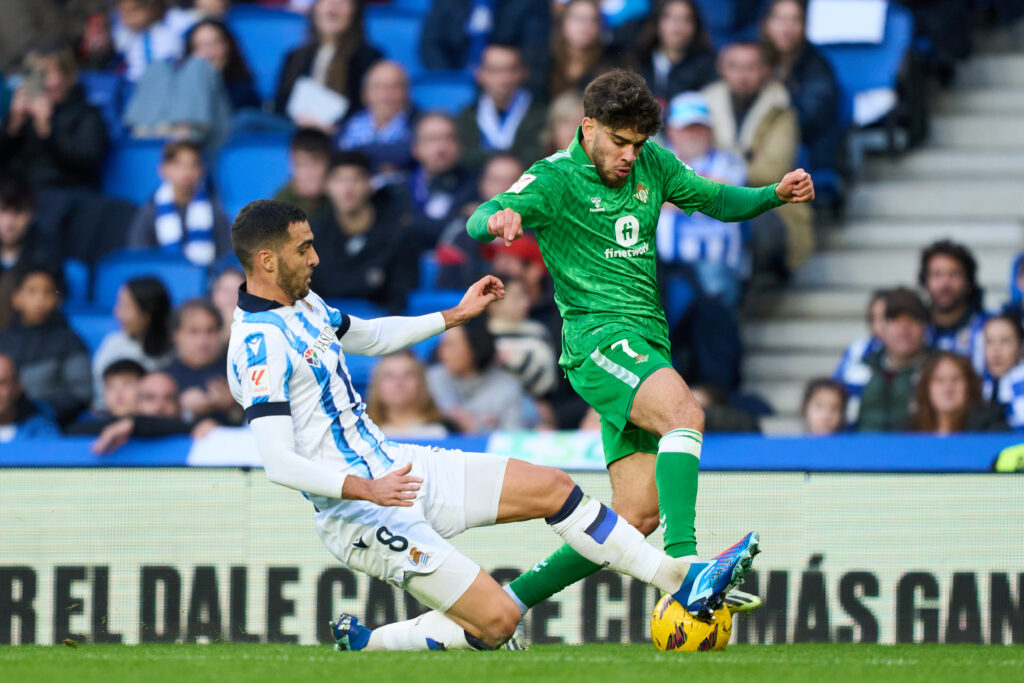 SAN SEBASTIAN, SPAIN - DECEMBER 17: Ez Abde of Real Betis duels for the ball with Mikel Merino of Real Sociedad during the LaLiga EA Sports match between Real Sociedad and Real Betis at Reale Arena on December 17, 2023 in San Sebastian, Spain.