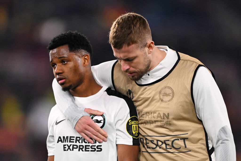 ROME, ITALY - MARCH 07: Ansu Fati of Brighton & Hove Albion is consoled by Adam Webster of Brighton & Hove Albion at full-time following the team's defeat in the UEFA Europa League 2023/24 round of 16 first leg match between AS Roma and Brighton & Hove Albion at Stadio Olimpico on March 07, 2024 in Rome, Italy.