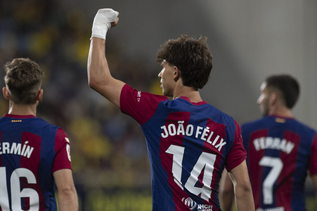 Barcelona's Portuguese forward #14 Joao Felix celebrates with teammates after scoring during the Spanish league football match between Cadiz CF and FC Barcelona at the Nuevo Mirandilla stadium in Cadiz on April 13, 2024.