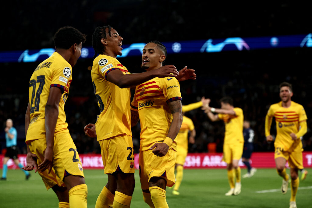 Barcelona's French defender #23 Jules Kounde (2L) congratulates Barcelona's Brazilian forward #11 Raphinha (C) after scoring Barcelona's first goal during the UEFA Champions League quarter final first leg football match between Paris Saint-Germain (PSG) and FC Barcelona at the Parc des Princes stadium in Paris on April 10, 2024.