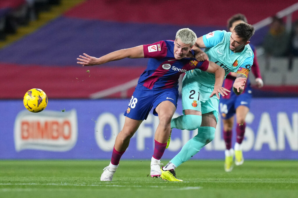 BARCELONA, SPAIN - MARCH 08: Marc Guiu of FC Barcelona and Antonio Raillo of RCD Mallorca battle for the ball during the LaLiga EA Sports match between FC Barcelona and RCD Mallorca at Estadi Olimpic Lluis Companys on March 08, 2024 in Barcelona, Spain.