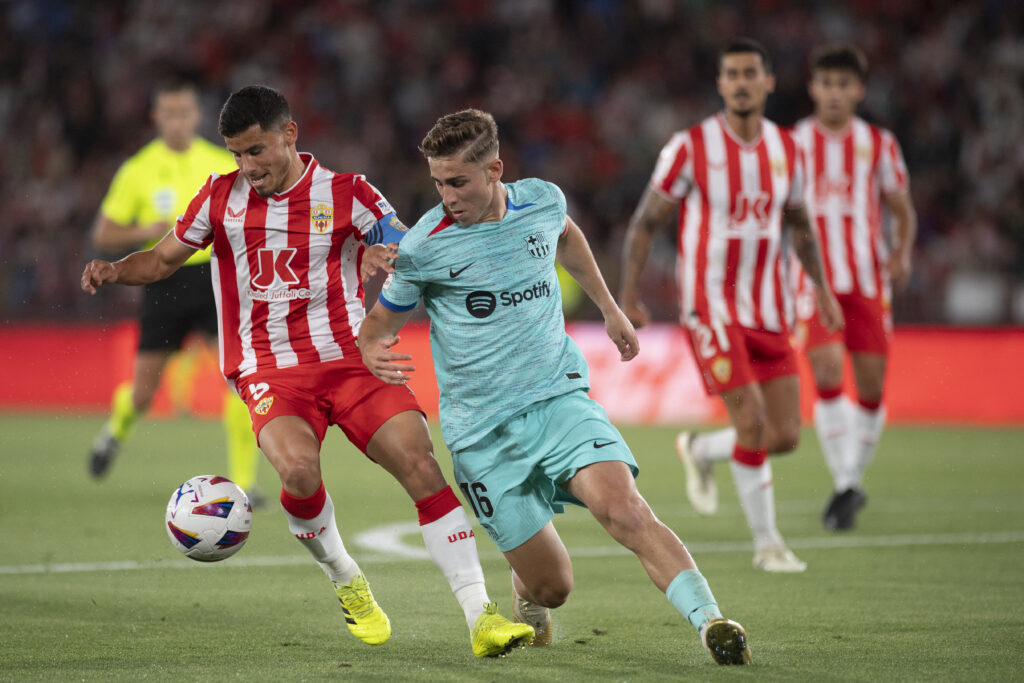 Almeria's Argentine midfielder #05 Lucas Robertone and Barcelona's Spanish midfielder #16 Fermin Lopez vie for the ball during the Spanish league football match between UD Almeria and FC Barcelona at the Municipal Stadium of the Mediterranean Games in Almeria on May 16, 2024.