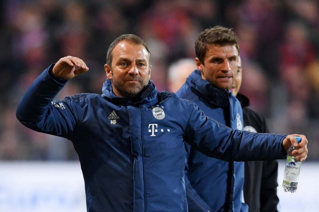 FREIBURG IM BREISGAU, GERMANY - DECEMBER 18: Hansi Flick, head coach of Bayern Munich reacts on the touchline next to Thomas Mueller during the Bundesliga match between Sport-Club Freiburg and FC Bayern Muenchen at Schwarzwald-Stadion on December 18, 2019 in Freiburg im Breisgau, Germany.