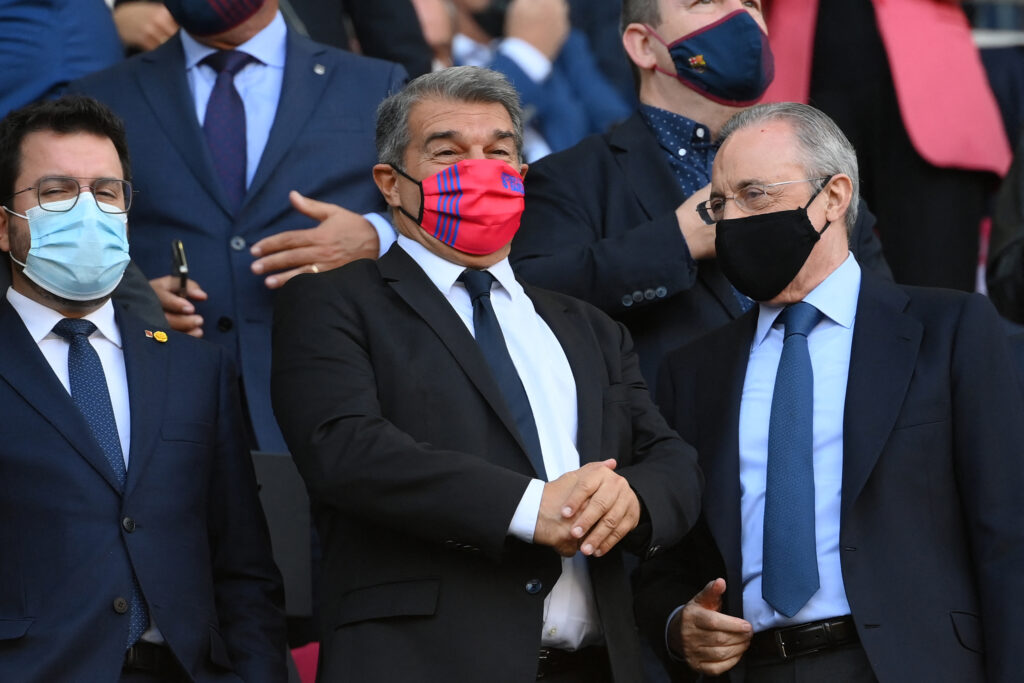 Barcelona president Joan Laporta (C) and Real Madrid president Florentino Perez (R) talk during the Spanish League football match between FC Barcelona and Real Madrid CF at the Camp Nou stadium in Barcelona on October 24, 2021.