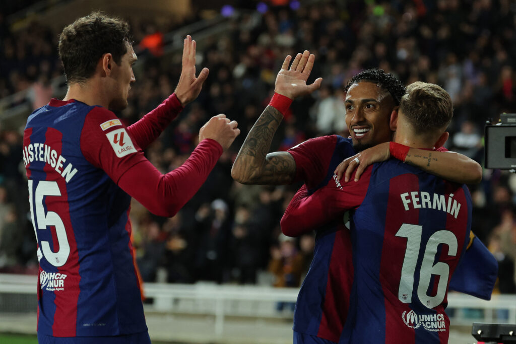 Barcelona's Spanish midfielder #16 Fermin Lopez celebrates with Barcelona's Brazilian forward #11 Raphinha (C) and Barcelona's Danish defender #15 Andreas Christensen after scoring his team's first goal during the Spanish league football match between FC Barcelona and Valencia CF at the Estadi Olimpic Lluis Companys in Barcelona on April 29, 2024.