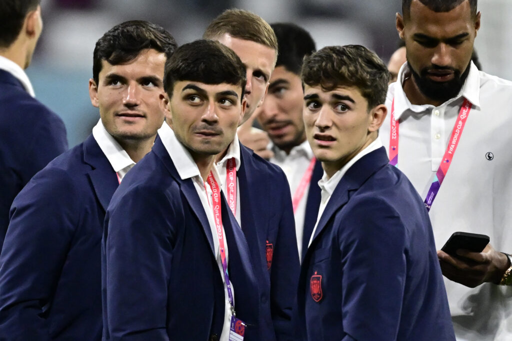 Spain's midfielder #26 Pedri (L) and Spain's midfielder #09 Gavi (R) react prior to during the Qatar 2022 World Cup Group E football match between Japan and Spain at the Khalifa International Stadium in Doha on December 1, 2022.