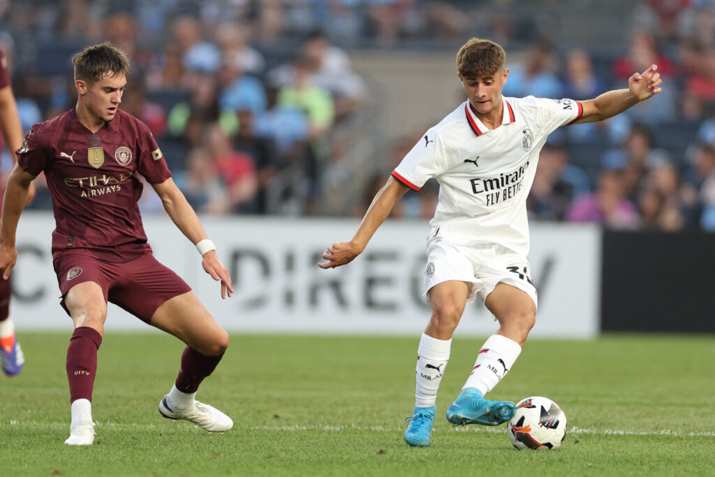 AC Milan's forward Mattia Liberali (R) controls the ball controls the ball during the pre-season club friendly football match between Manchester City and AC Milan at Yankee Stadium in New York on July 27, 2024.