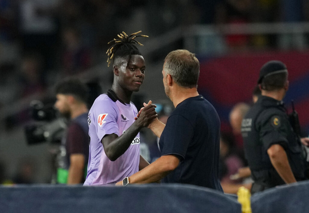 BARCELONA, SPAIN - AUGUST 24: Nico Williams of Athletic Club shakes hands with Hansi Flick, Head Coach of FC Barcelona, after the La Liga match between FC Barcelona and Athletic Club at Camp Nou on August 24, 2024 in Barcelona, Spain.