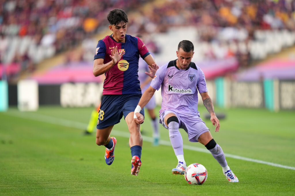 BARCELONA, SPAIN - AUGUST 24: Alex Berenguer of Athletic Club is challenged by Marc Bernal of FC Barcelona during the La Liga match between FC Barcelona and Athletic Club at Camp Nou on August 24, 2024 in Barcelona, Spain.