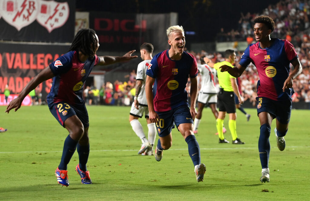 MADRID, SPAIN - AUGUST 27: Dani Olmo of FC Barcelona (C) celebrates scoring his sides second goal with teammates Jules Kounde (L) and Alejandro Balde (R) during the La Liga match between Rayo Vallecano and FC Barcelona at Estadio de Vallecas on August 27, 2024 in Madrid, Spain.