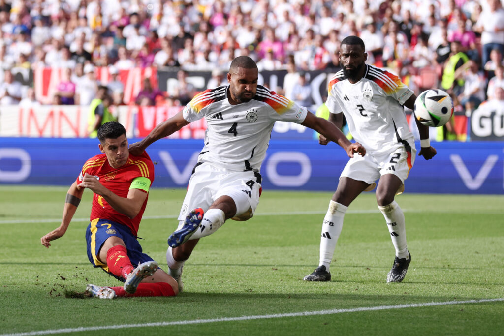 STUTTGART, GERMANY - JULY 05: Alvaro Morata of Spain shoots whilst under pressure from Jonathan Tah of Germany during the UEFA EURO 2024 quarter-final match between Spain and Germany at Stuttgart Arena on July 05, 2024 in Stuttgart, Germany.