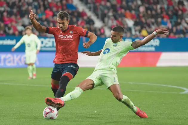 PAMPLONA, SPAIN - SEPTEMBER 28: Ferran Torres of FC Barcelona (R) and Lucas Torro of CA Osasuna battle for the ball during the LaLiga match between CA Osasuna and FC Barcelona at Estadio El Sadar on September 28, 2024 in Pamplona, Spain.