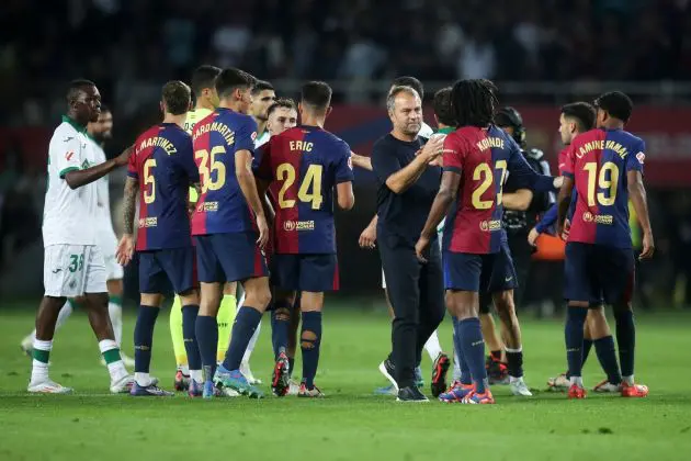 BARCELONA, SPAIN - SEPTEMBER 25: Hansi Flick, Head Coach of FC Barcelona, shakes hands with Jules Kounde of FC Barcelona following the teams' victory during the La Liga EA Sports match between FC Barcelona and Getafe CF at Camp Nou on September 25, 2024 in Barcelona, Spain.