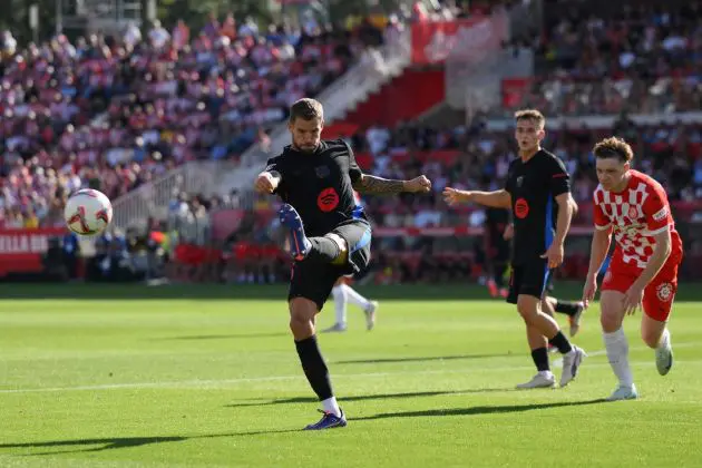 GIRONA, SPAIN - SEPTEMBER 15: Inigo Martinez of FC Barcelona clears the ball under pressure from Viktor Tsyhankov of Girona FC during the LaLiga match between Girona FC and FC Barcelona at Montilivi Stadium on September 15, 2024 in Girona, Spain.