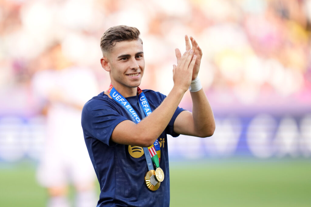 BARCELONA, SPAIN - AUGUST 24: Fermin Lopez of FC Barcelona acknowledges the fans while wearing the UEFA 2024 winer medal and the Paris 2024 Olympic gold medal prior to the La Liga match between FC Barcelona and Athletic Club at Camp Nou on August 24, 2024 in Barcelona, Spain.