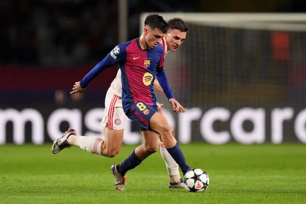 BARCELONA, SPAIN - OCTOBER 23: Pedri of FC Barcelona runs with the ball whilst under pressure from Joao Palhinha of Bayern Munich during the UEFA Champions League 2024/25 League Phase MD3 match between FC Barcelona and FC Bayern Munchen at Estadi Olimpic Lluis Companys on October 23, 2024 in Barcelona, Spain.