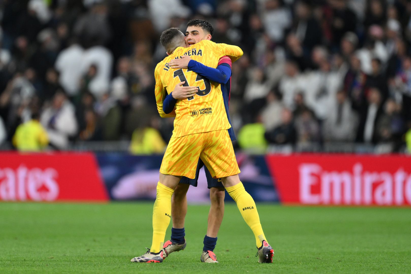 MADRID, SPAIN - OCTOBER 26: Inaki Pena and Pedri of FC Barcelona celebrate victory following the LaLiga match between Real Madrid CF and FC Barcelona at Estadio Santiago Bernabeu on October 26, 2024 in Madrid, Spain.