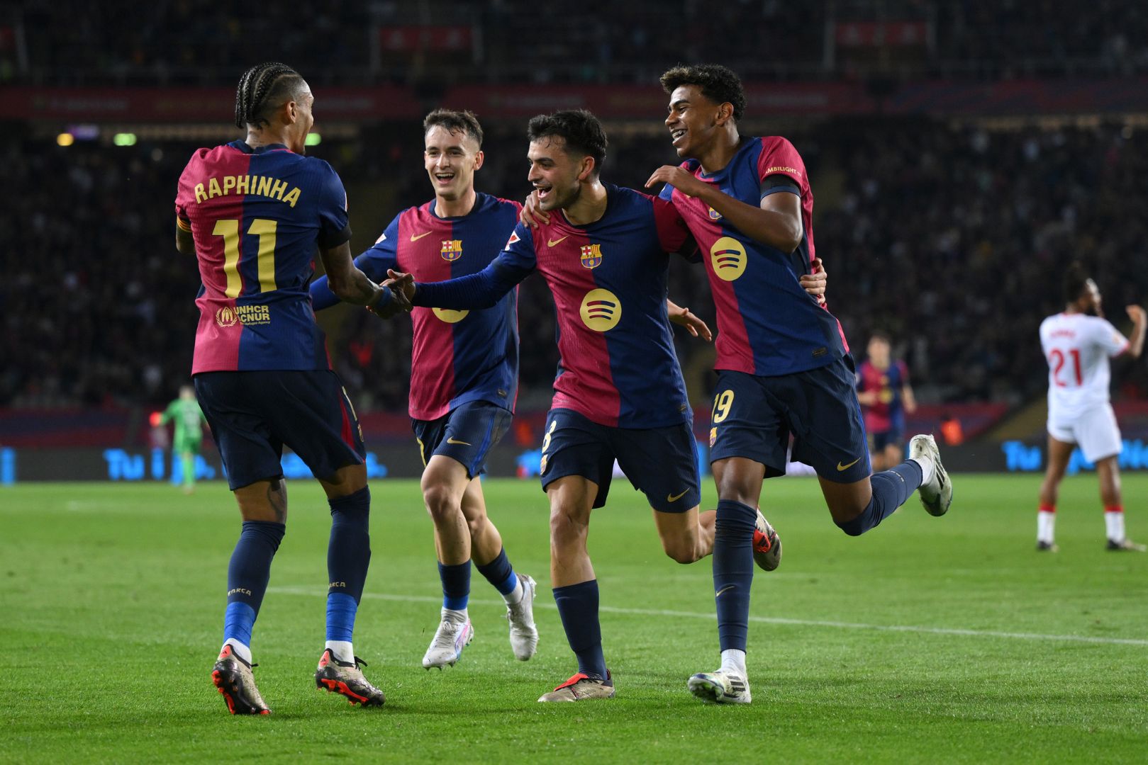 BARCELONA, SPAIN - OCTOBER 20: Pedri of FC Barcelona celebrates with teammates Raphinha, Marc Casado and Lamine Yamal after scoring his team's second goal during the La Liga EA Sports match between FC Barcelona and Sevilla FC at Estadi Olimpic Lluis Companys on October 20, 2024 in Barcelona, Spain.