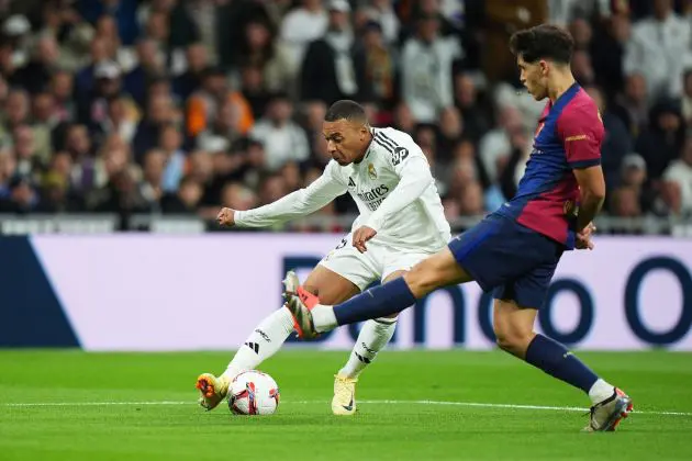 MADRID, SPAIN - OCTOBER 26: Kylian Mbappe of Real Madrid is challenged by Pau Cubarsi of FC Barcelona during the LaLiga match between Real Madrid CF and FC Barcelona at Estadio Santiago Bernabeu on October 26, 2024 in Madrid, Spain.