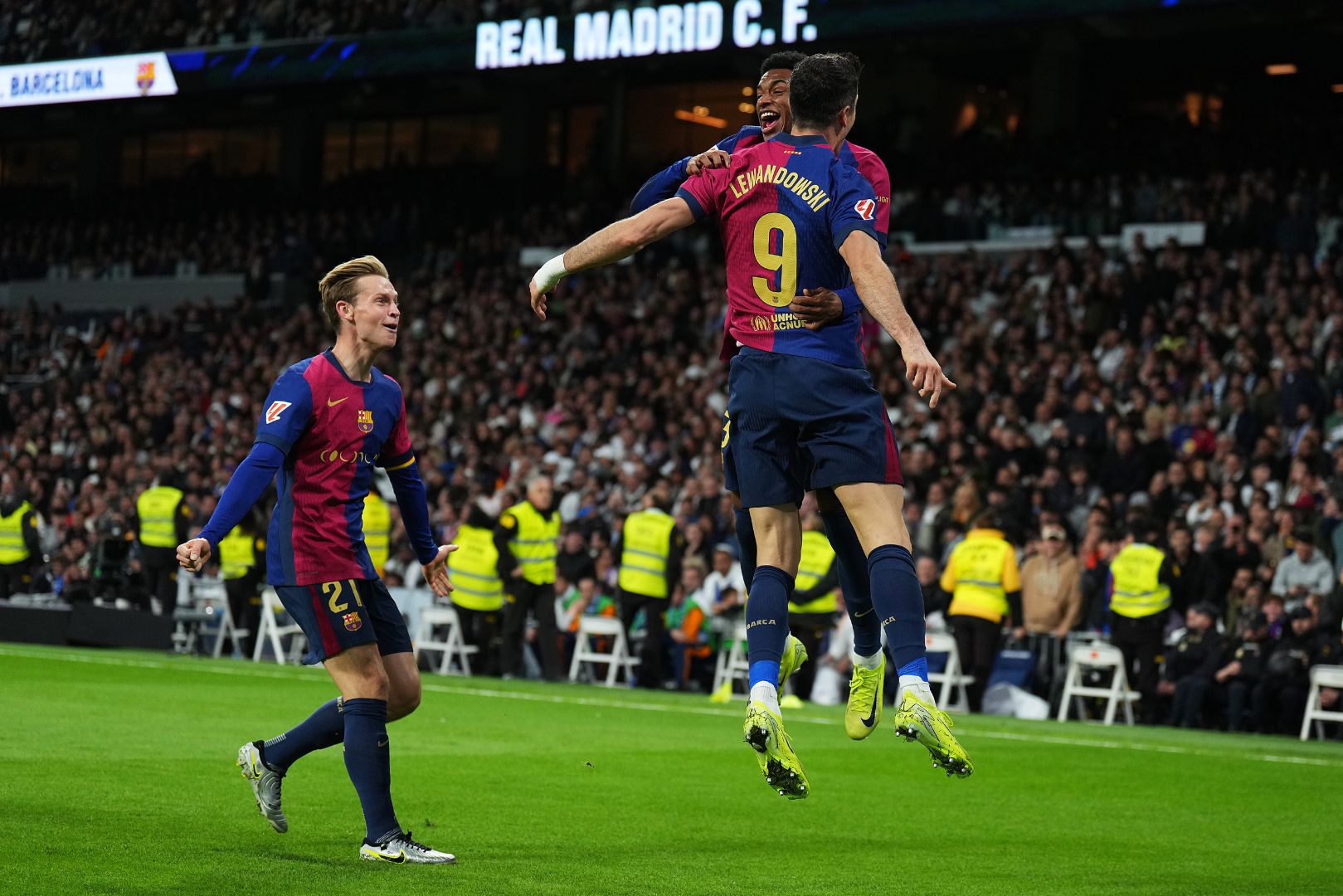 MADRID, SPAIN - OCTOBER 26: Robert Lewandowski of FC Barcelona celebrates scoring his team's second goal with teammates Alejandro Balde and Frenkie de Jong during the LaLiga match between Real Madrid CF and FC Barcelona at Estadio Santiago Bernabeu on October 26, 2024 in Madrid, Spain.