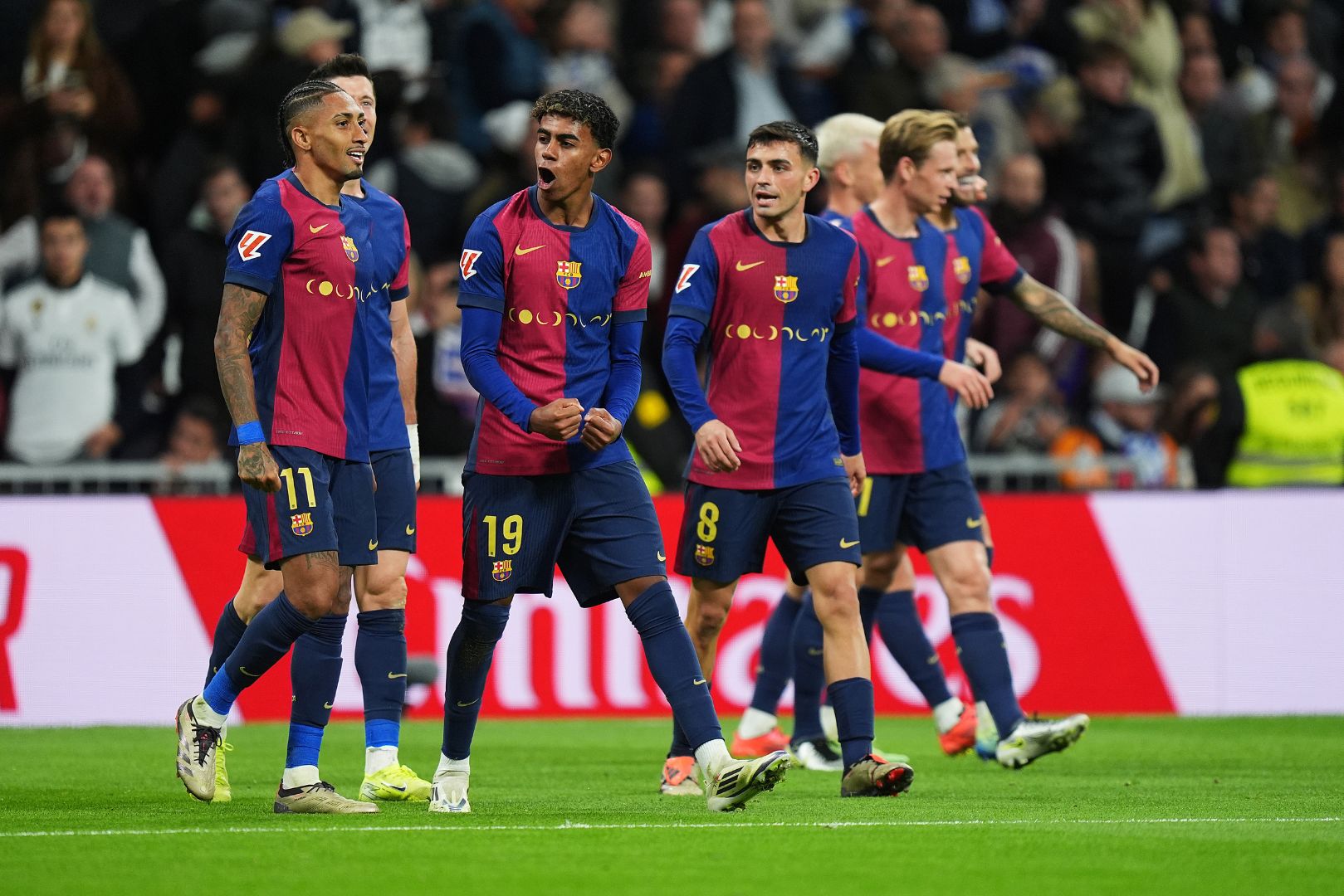 MADRID, SPAIN - OCTOBER 26: Raphinha of FC Barcelona celebrates scoring his team's fourth goal with teammates during the LaLiga match between Real Madrid CF and FC Barcelona at Estadio Santiago Bernabeu on October 26, 2024 in Madrid, Spain.