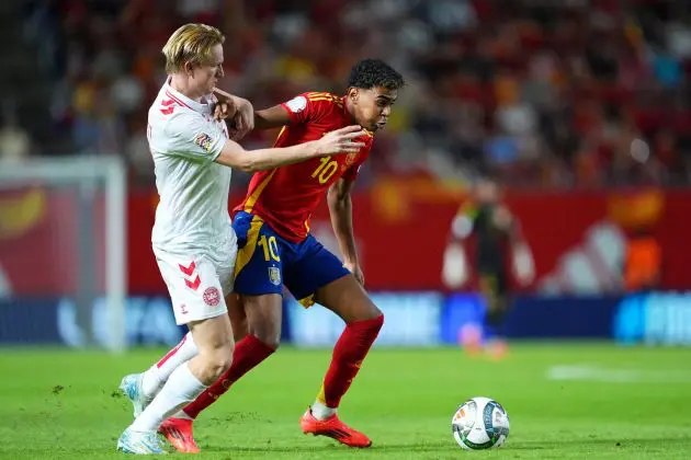 MURCIA, SPAIN - OCTOBER 12: Lamine Yamal of Spain is challenged by Victor Kristiansen of Denmark during the UEFA Nations League 2024/25 League A Group A4 match between Spain and Denmark at Nueva Condomina on October 12, 2024 in Murcia, Spain.