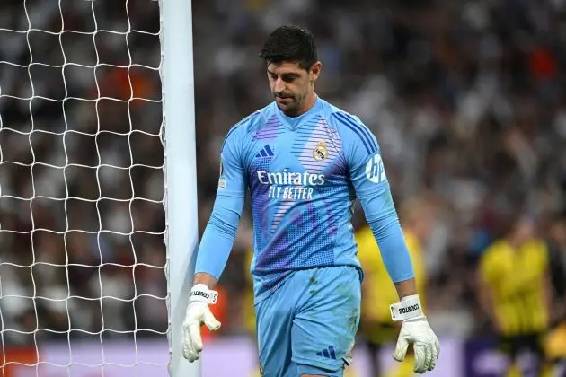 MADRID, SPAIN - OCTOBER 22: Thibaut Courtois of Real Madrid reacts after Jamie Bynoe-Gittens of Borussia Dortmund (not pictured) scores his team's second goal during the UEFA Champions League 2024/25 League Phase MD3 match between Real Madrid C.F. and Borussia Dortmund at Estadio Santiago Bernabeu on October 22, 2024 in Madrid, Spain.