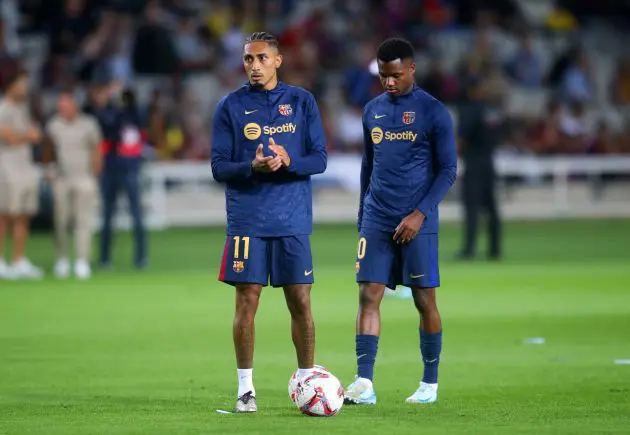 BARCELONA, SPAIN - SEPTEMBER 25: Raphinha and Ansu Fati of FC Barcelona warm up prior to the La Liga EA Sports match between FC Barcelona and Getafe CF at Camp Nou on September 25, 2024 in Barcelona, Spain.