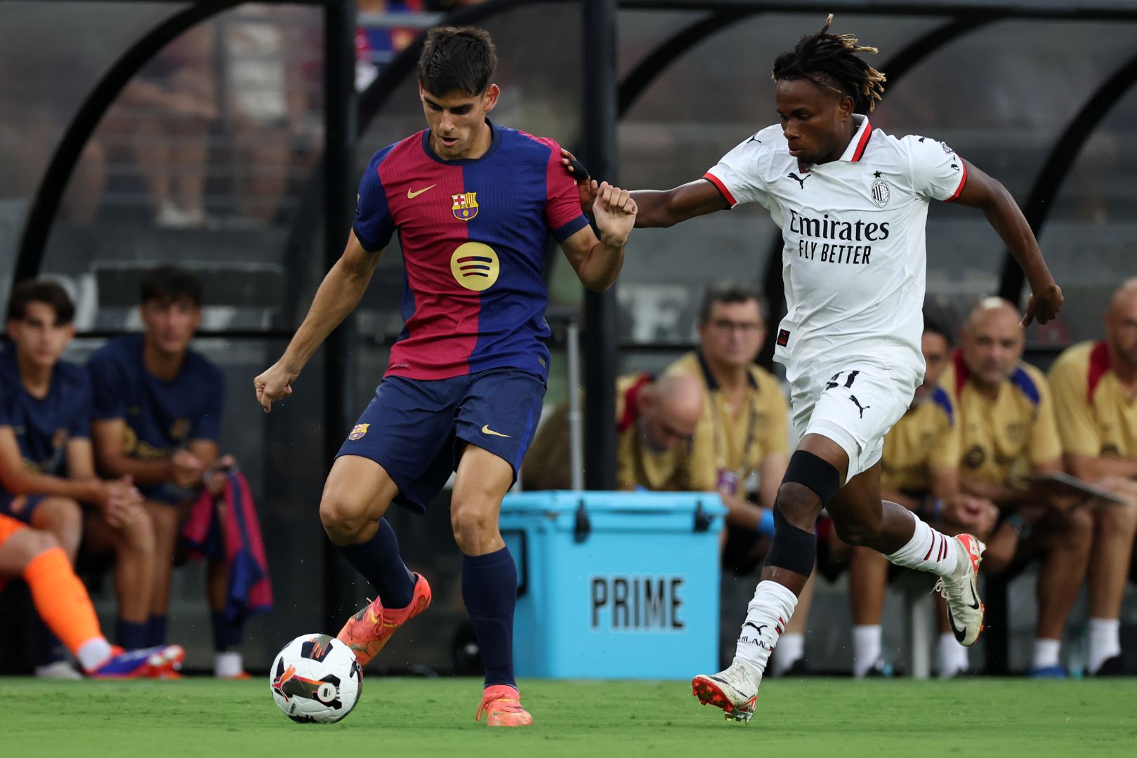 BALTIMORE, MARYLAND - AUGUST 06: Gerard Martin of FC Barcelona fights for the ball with Samuel Chukwueze of AC Milan during a Pre-Season Friendly match between FC Barcelona and AC Milan at M&T Bank Stadium on August 06, 2024 in Baltimore, Maryland.