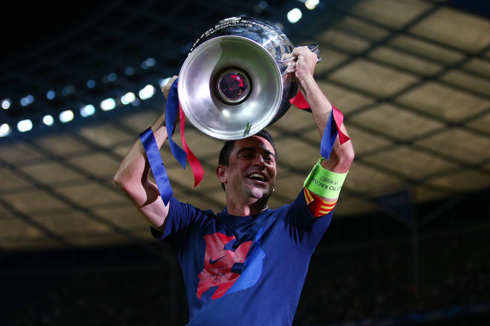 BERLIN, GERMANY - JUNE 06: Xavi Hernandez of Barcelona lifts the trophy as he celebrates victory after the UEFA Champions League Final between Juventus and FC Barcelona at Olympiastadion on June 6, 2015 in Berlin, Germany.